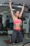 Fitness Woman Performing Hanging Leg Raises Exercise Stock Photo