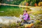Little Girl Playing With Dogs On Th Coast Of The Black Lake ( Crno Jezero),durmitor, Montenegro Stock Photo
