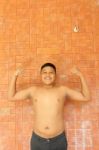 Thai Boy Muscle Flexing Stock Photo