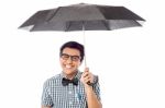 Smiling Young Man With An Umbrella Stock Photo