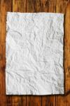 White Crumpled Paper On Wood Background Stock Photo