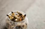 Smoked Cigarettes Butts In The Glass Ashtray With Grey Background Stock Photo