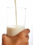 Pouring Milk Into Glass Stock Photo