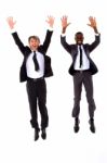 Two Businessmen Jumping Stock Photo