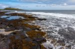 View Of Dunstanburgh Castle At Craster Northumberland Stock Photo