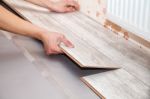 Man Laying Laminate Flooring Stock Photo