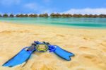 Snorkling Gear On The Beach With Water Bungalows And The Beach In Maldives Stock Photo