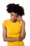Calm And Thoughtful Curly Haired Young Woman Stock Photo