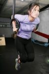 Woman Balancing On Rings On Gym Stock Photo