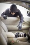 Thief Stealing Camera From Car Stock Photo