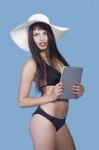 Woman In A Bikini With Tablet Pc Stock Photo