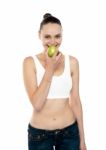 Fitness Woman Eating Green Apple Stock Photo