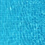 Blue Rippled Water Background In Swimming Pool Stock Photo