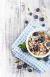 Bowl Of Muesli With Fresh Blueberries On White Wooden Table Stock Photo