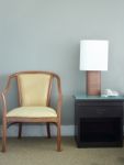 Chair And Table Lamp In Bedroom Stock Photo