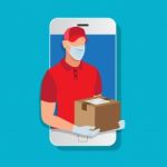 Delivery Man Wearing A Face Mask And Gloves Holding A Box Post Stock Photo