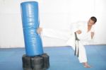 Black Belt Karate Man Practicing In A Sandbag Stock Photo