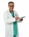 Senior Doctor Holding Tablet Pc Stock Photo