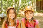Two Happy Girlfriends Smiling In The Adventure Park Stock Photo