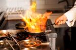 Chef Cooking In Kitchen Stove Stock Photo