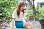 Portrait Of Thai Student University Beautiful Girl Using Her Smart Phone Stock Photo
