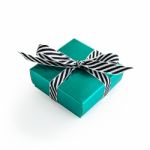 Green Gift Box With Black And White Ribbon Stock Photo