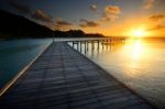 The Beautiful Wooden Pier With Sunrise At Rayong, Thailand Stock Photo