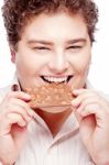 Chubby Man Eating Chocolate Stock Photo