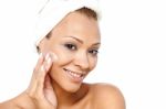 Beautiful Woman Applying Lotion On Her Face Stock Photo