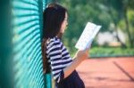 Asian Girl And School Book In Hand Toothy Smiling Face With Happiness Emotion In Green Park Use For Education Theme And Related Stock Photo