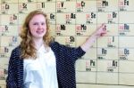 Dutch Teenage Girl Pointing Finger At Periodic Table Stock Photo