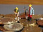 Miniature Worker People Stand On Euro Coins. Business And Idea C Stock Photo