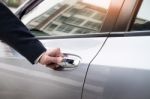 Chauffeur S Hand On Handle. Close-up Of Man In Formal Wear Openi Stock Photo