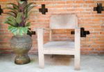 Wooden Chair In Front Of Brick Wall Stock Photo
