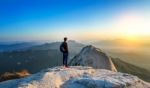 Man Stands On The Peak Of Stone In Bukhansan National Park,seoul In South Korea And Watching To Sunrise. Beautiful Moment The Miracle Of Nature Stock Photo