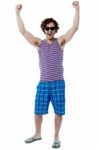 Excited Young Man Raising His Arm Stock Photo