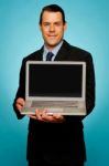 Corporate Executive Showing Laptop To You Stock Photo