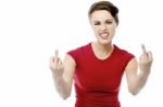 Young Woman Making Obscene Hand Gesture Stock Photo