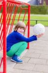 Young Crouching Girl With Ball On Hands In Metall Goal Stock Photo