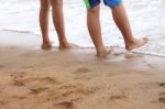 Children Are Walking On Beach Stock Photo