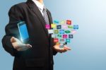 Mobile Phone With Applications Icon In The Hands Of Businessmen Stock Photo