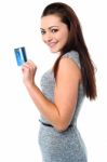 Fashionable Young Girl Holding Up A Credit Card Stock Photo