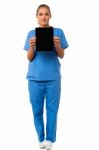 Pretty Doctor Showcasing A Portable Tablet Stock Photo