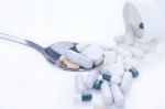 Pills And Tablets On Spoon Stock Photo