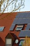 Solar Panels On A Red Roof Stock Photo