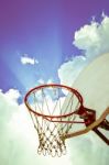 Old Basketball Board And Hoop On Blue Sky With Clouds Background Stock Photo