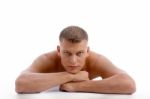 Laying Muscular Male Looking At You Stock Photo