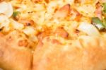 Delicious Pizza Pan With Cheese Crust Stock Photo