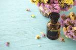 Essential Oil With Flower Background Stock Photo