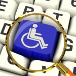 Disabled Key Magnified Shows Wheelchair Access Or Handicapped Stock Photo
